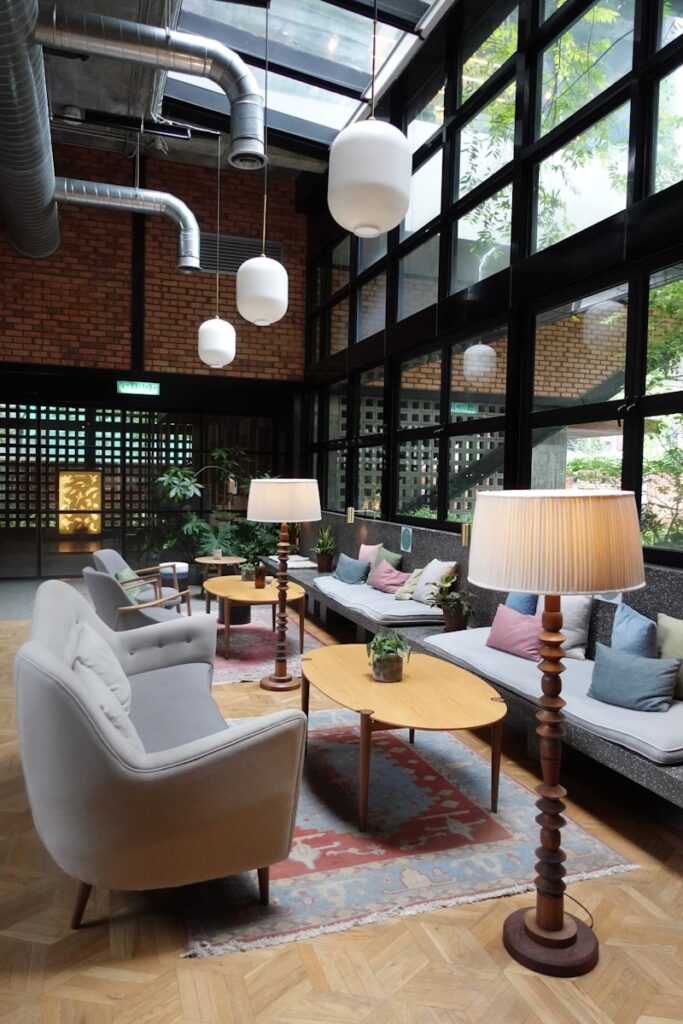 a living room filled with furniture and lots of windows